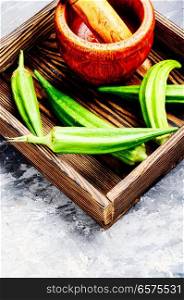 Fresh harvest raw green organic okra in a wooden box.Vegetarianism. Raw green organic okra