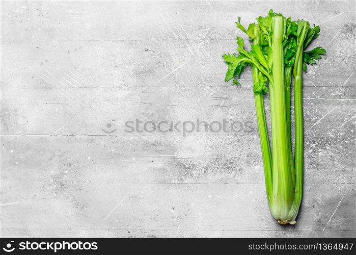 Fresh, healthy celery. On white rustic background. Fresh, healthy celery.