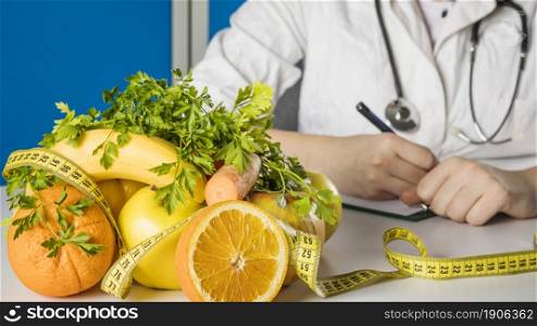 fresh healthy fruits with measuring tape dietician s desk. High resolution photo. fresh healthy fruits with measuring tape dietician s desk. High quality photo