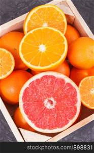Fresh healthy orange, grapefruit and mandarins in wooden box. Fruits as source natural minerals and vitamins. Fresh orange, grapefruit and mandarins in wooden box. Fruits as source minerals and vitamins