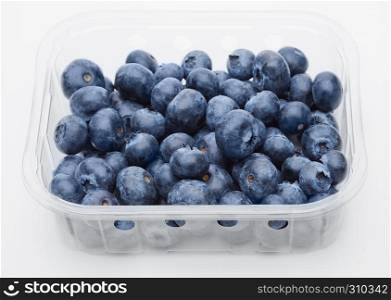 Fresh healthy organic blueberry in plastic container on white background