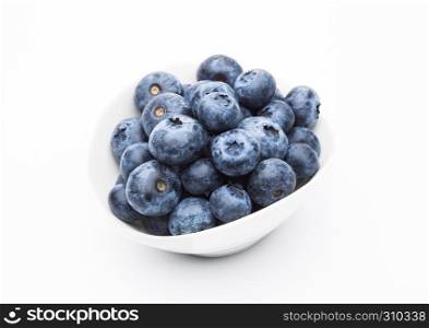 Fresh healthy organic blueberry in white bowl on white background