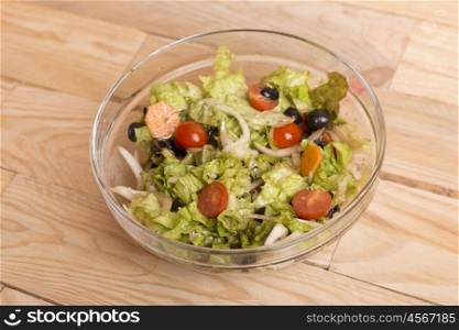 Fresh healthy salad on wooden table