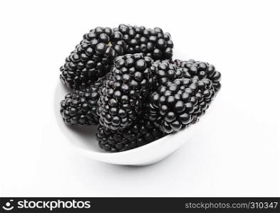 Fresh healthy summer blackberries in white bowl on white background