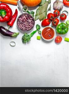 Fresh healthy vegetables. Raw vegetables with spices and beans. On the steel background .. Raw vegetables with spices and beans.