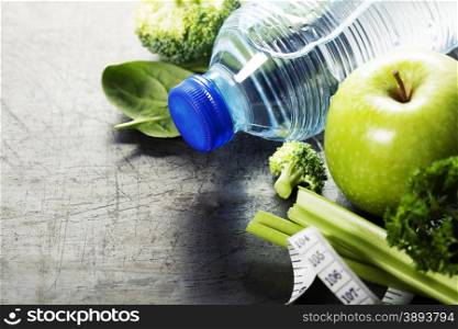 Fresh healthy vegetables, water and measuring tape. Health, sport and diet concept