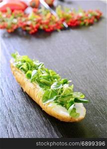 Fresh healthy white bread roll with Valerianella locusta salad.
