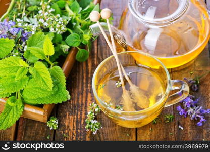 fresh herbal tea in cup and on a table