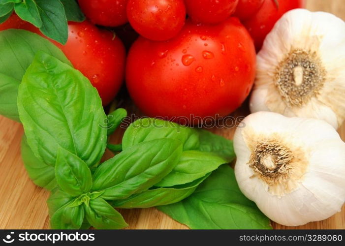 Fresh herbs and vegetables to make spaghetti sauce, including tomatoes, basil, oregano and garlic.. Basil And Tomatoes