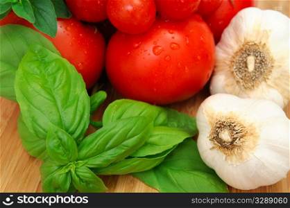 Fresh herbs and vegetables to make spaghetti sauce, including tomatoes, basil, oregano and garlic.. Basil And Tomatoes