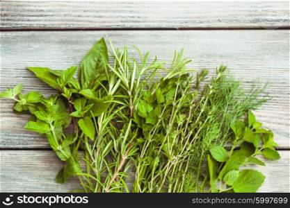 Fresh herbs on the wooden background with copy text. The Fresh herbs