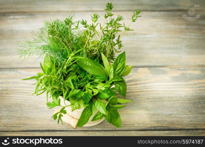 Fresh herbs outdoor on the wooden table. Fresh herbs
