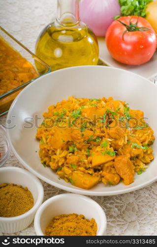 fresh home made curry beef rice and potatoes with ingredients around composition