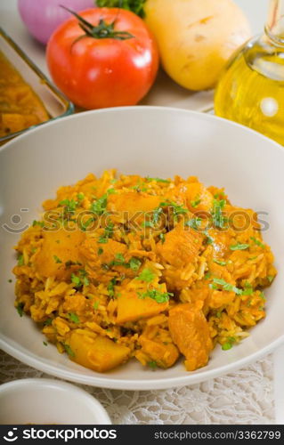 fresh home made curry beef rice and potatoes with ingredients around composition