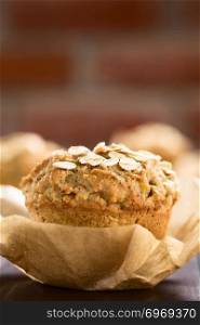 Fresh homemade apple and oatmeal muffin with oats on top (Selective Focus, Focus on the first oats on top of the muffin). Apple and Oatmeal Muffin