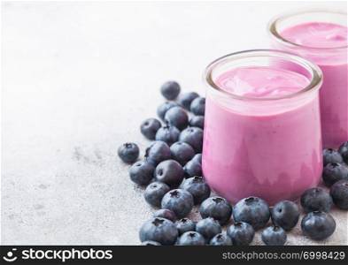 Fresh homemade creamy blueberry yoghurt with fresh blueberries on stone table background