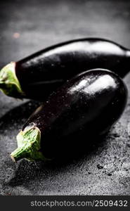 Fresh homemade eggplant on the table. On a black background. High quality photo. Fresh homemade eggplant on the table. 