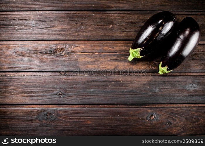 Fresh homemade eggplant on the table. On a wooden background. High quality photo. Fresh homemade eggplant on the table. 