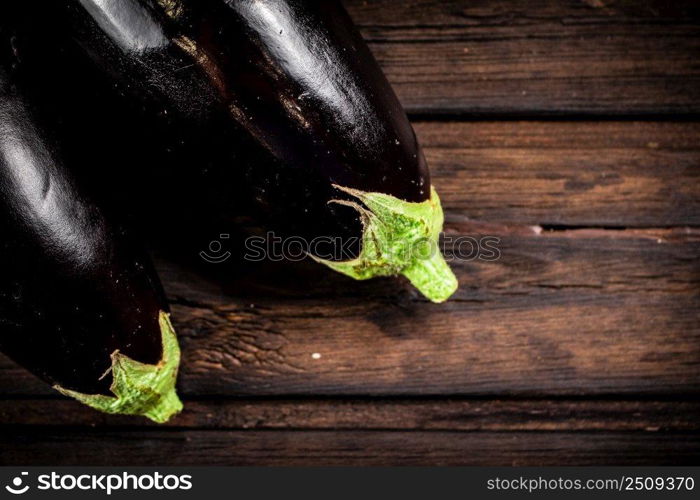 Fresh homemade eggplant on the table. On a wooden background. High quality photo. Fresh homemade eggplant on the table. 