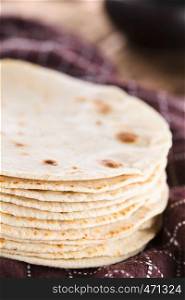 Fresh homemade flour tortillas on kitchen towel (Selective Focus, Focus on the front of the tortillas). Homemade Flour Tortillas