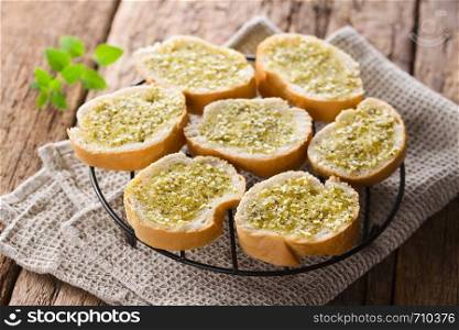 Fresh homemade garlic bread, slices of baguette seasoned with garlic, oregano, salt, pepper and olive oil (Selective Focus, Focus one third into the image). Fresh Garlic Bread