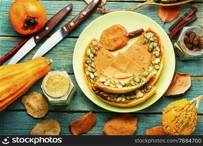 Fresh homemade pumpkin pie on plate.Pumpkin tart on rustic wooden background.Thanksgiving. Autumn pumpkin pie on a plate