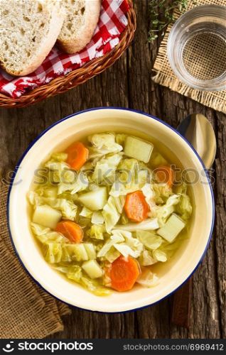 Fresh homemade vegan cabbage soup with carrot and potato served in bowl, photographed overhead  Selective Focus, Focus on the dish . Fresh Vegan Cabbage Soup