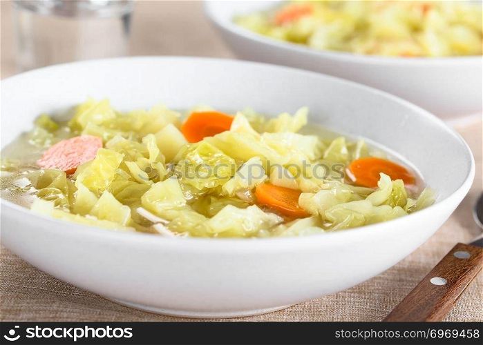 Fresh homemade vegan cabbage soup with carrot and potato served in bowl  Selective Focus, Focus in the middle of the image . Fresh Vegan Cabbage Soup
