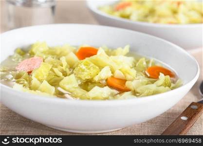 Fresh homemade vegan cabbage soup with carrot and potato served in bowl  Selective Focus, Focus in the middle of the image . Fresh Vegan Cabbage Soup