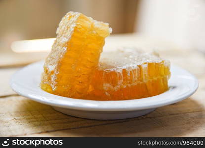 Fresh honey / Close up of yellow sweet honeycomb on white plate natural healthy food