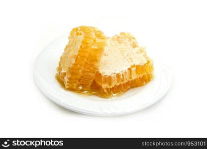 Fresh honey / Close up of yellow sweet honeycomb slice on white plate natural healthy food
