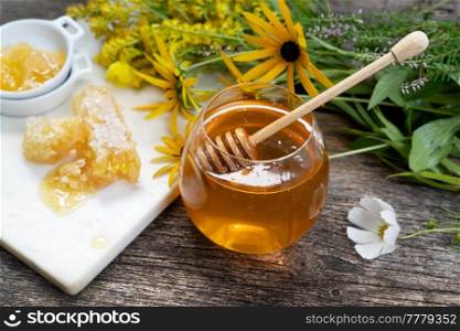 fresh honey in jar with honeycombs on rustic background close up. fresh honey with honeycombs