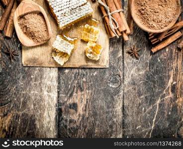 Fresh honey with cinnamon. On wooden background.. Fresh honey with cinnamon.