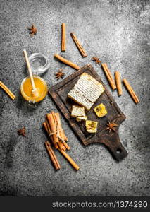 Fresh honey with cinnamon sticks. On rustic background .. Fresh honey with cinnamon sticks.