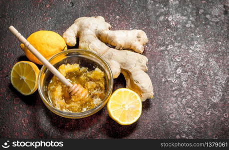 Fresh honey with ginger and lemon. On rustic background.. Fresh honey with ginger and lemon.