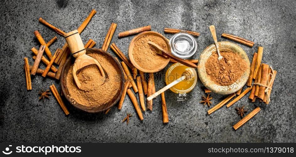 Fresh honey with ground cinnamon in a bowl. On rustic background .. Fresh honey with ground cinnamon in a bowl.