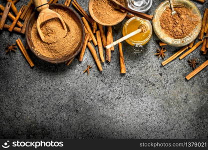 Fresh honey with ground cinnamon in a bowl. On rustic background .. Fresh honey with ground cinnamon in a bowl.