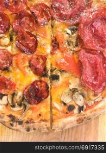 Fresh hot pizza. Italian fast food. Fresh hot pizza with salami and cheese. Delicious italian traditional fast food