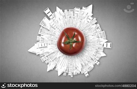 Fresh idea. Tomato against black background with business sketches