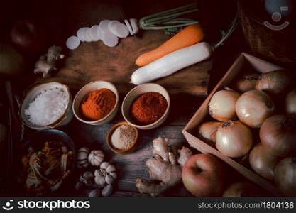 Fresh ingredients and vegetables Placed in the table For making Kimchi Which contains ingredients such as ginger, garlic, salt, onion, sugar, gochugaru (Korean chili). Kimchi is a healthy food.