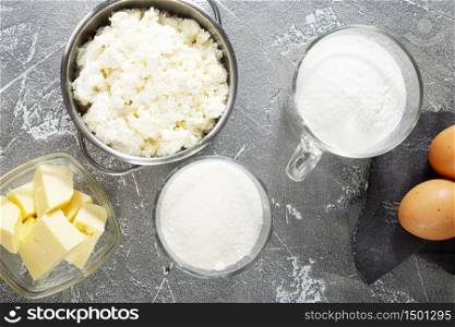 Fresh ingredients for baking, cottage cheese milk sugar eggs on a table