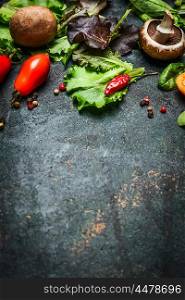 Fresh ingredients for tasty cooking and salad making on dark rustic background, top view, frame.