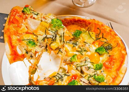 fresh italian thin style vegetarian pizza with fresh mixed vegetables close up