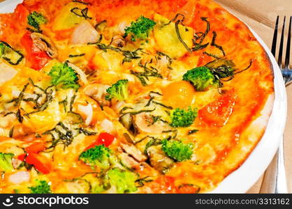 fresh italian thin style vegetarian pizza with fresh mixed vegetables close up