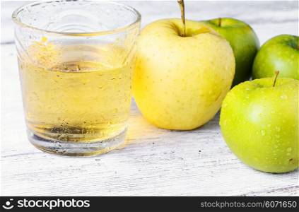Fresh juice from the fruit green apple on light background. apple and glass of juice