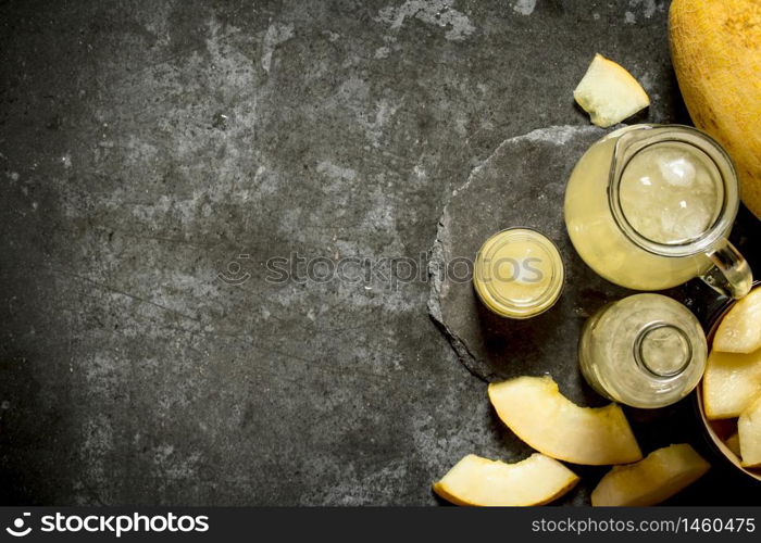 Fresh juice of the melon . On a stone background.. Fresh juice of the melon .