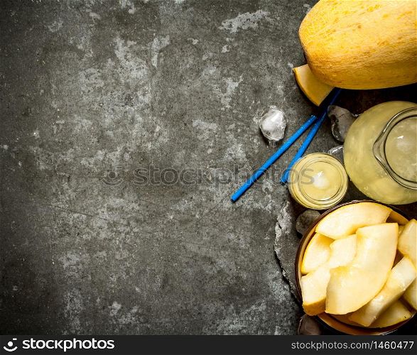 Fresh juice of the melon . On a stone background.. Fresh juice of the melon .