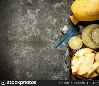 Fresh juice of the melon . On a stone background.. Fresh juice of the melon .