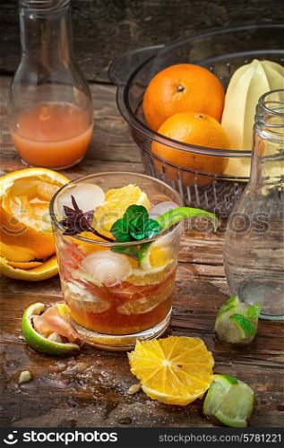 fresh juice of tropical citrus fruits on wooden background in rustic style.Selective focus. fresh juice of tropical citrus fruits on wooden background