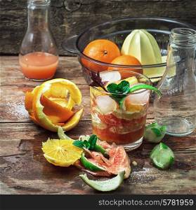 fresh juice of tropical citrus fruits on wooden background.Selective focus. fresh juice of tropical citrus fruits on wooden background
